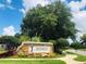 Entrance to Mayfair Run featuring stone sign and lush landscaping at 14700 Chadbury Ct, Orlando, FL 32828