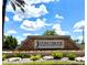 Stone entrance sign for Stoneybrook golf community with lush landscaping under a bright blue sky at 14700 Chadbury Ct, Orlando, FL 32828