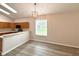 Bright dining room with wooden floors, connecting to an open-concept kitchen at 14700 Chadbury Ct, Orlando, FL 32828