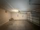 Spacious garage with concrete floor and attached garage door; clean and ready for vehicles or storage at 14700 Chadbury Ct, Orlando, FL 32828