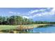 Beautiful golf course featuring a serene pond, lush green fairways, and mature trees at 14700 Chadbury Ct, Orlando, FL 32828