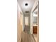Hallway features modern flooring and lighting fixtures, with doorways leading to rooms and bathroom at 14700 Chadbury Ct, Orlando, FL 32828