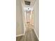 Hallway features modern, wood-look flooring and neutral walls leading to other areas of the home at 14700 Chadbury Ct, Orlando, FL 32828