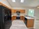 Well-lit kitchen with stainless steel appliances, wooden cabinets and a skylight at 14700 Chadbury Ct, Orlando, FL 32828