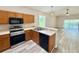 Modern kitchen features stainless steel appliances and an open layout with views of the pool at 14700 Chadbury Ct, Orlando, FL 32828