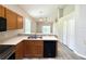 Spacious kitchen with stainless steel sink and appliances leading into the living room at 14700 Chadbury Ct, Orlando, FL 32828