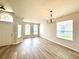 Inviting living room with new flooring and arched windows allowing for natural light at 14700 Chadbury Ct, Orlando, FL 32828