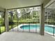 Sparkling pool inside screened enclosure featuring lush greenery providing a private oasis for relaxation and fun at 14700 Chadbury Ct, Orlando, FL 32828