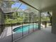 Enjoy a sparkling screened-in pool surrounded by lush greenery; perfect for outdoor relaxation and entertainment at 14700 Chadbury Ct, Orlando, FL 32828