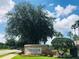 Community fitness center sign amid trees, featuring lush, green landscape at 14700 Chadbury Ct, Orlando, FL 32828
