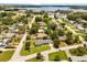Aerial view of a residential area with mature trees and access to a nearby lake at 1505 N Lake Mirror Nw Dr, Winter Haven, FL 33881