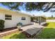 Outdoor living space features a wooden deck, screened lanai, and well-maintained yard at 1505 N Lake Mirror Nw Dr, Winter Haven, FL 33881