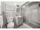 Classic bathroom with gray tiling, a glass-enclosed shower, and a modern vanity at 1505 N Lake Mirror Nw Dr, Winter Haven, FL 33881