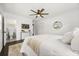 Inviting bedroom with neutral tones, hardwood floors, a ceiling fan, and bright natural light at 1505 N Lake Mirror Nw Dr, Winter Haven, FL 33881