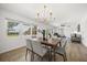 Bright dining area with a gold chandelier and view of the well-lit, comfortable living area at 1505 N Lake Mirror Nw Dr, Winter Haven, FL 33881
