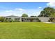 Charming single-story home with a well-manicured lawn, a covered porch, and an attached two car garage at 1505 N Lake Mirror Nw Dr, Winter Haven, FL 33881