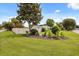 Well-manicured front yard with lush lawn and mature landscaping at 1505 N Lake Mirror Nw Dr, Winter Haven, FL 33881
