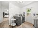 Functional laundry room with modern washer and dryer, shiplap wall, and convenient access to outside at 1505 N Lake Mirror Nw Dr, Winter Haven, FL 33881