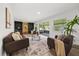 Comfortable living room with neutral tones, built-in shelving, sliding door access, and natural light at 1505 N Lake Mirror Nw Dr, Winter Haven, FL 33881