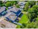 Aerial view of blue two-story home with landscaped yard, water feature, and privacy fence at 1609 E Kaley Ave, Orlando, FL 32806