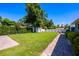 Expansive backyard featuring lush lawn, mature trees, and manicured hedges for outdoor enjoyment at 1609 E Kaley Ave, Orlando, FL 32806