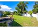 Beautiful backyard featuring well-maintained lawn, mature trees, charming landscaping, and privacy fence at 1609 E Kaley Ave, Orlando, FL 32806