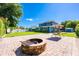 Spacious backyard with patio, fire pit, and swing, perfect for outdoor entertaining and relaxation at 1609 E Kaley Ave, Orlando, FL 32806