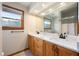 Bright bathroom showcasing double sinks with marble countertops and modern fixtures at 1609 E Kaley Ave, Orlando, FL 32806