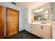 Updated bathroom offers white cabinetry, modern fixtures, and a sleek design with a warm, inviting ambiance at 1609 E Kaley Ave, Orlando, FL 32806