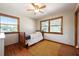 Cozy bedroom with hardwood floors, two large windows, and a full-sized bed at 1609 E Kaley Ave, Orlando, FL 32806