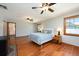 Inviting bedroom with hardwood floors, natural light, and ceiling fans creates a serene and relaxing atmosphere at 1609 E Kaley Ave, Orlando, FL 32806