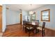 Bright dining room showcases hardwood floors, natural light, and a classic wooden table with seating for six at 1609 E Kaley Ave, Orlando, FL 32806