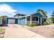 Charming two-story home with a well-manicured front yard, covered porch, and attached garage at 1609 E Kaley Ave, Orlando, FL 32806