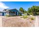 Charming two-story home featuring a covered front porch, landscaped yard, and gravel driveway at 1609 E Kaley Ave, Orlando, FL 32806