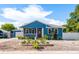 Charming blue home featuring a cozy front porch, manicured landscaping, and a welcoming entrance at 1609 E Kaley Ave, Orlando, FL 32806