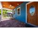 Inviting front porch with wood ceiling, rocking chair, and beautifully stained front door at 1609 E Kaley Ave, Orlando, FL 32806