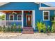 Charming front porch with wood ceiling, white railings, and well-maintained landscaping at 1609 E Kaley Ave, Orlando, FL 32806
