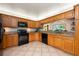 Functional kitchen featuring light wood cabinets, modern appliances, and tile flooring at 1609 E Kaley Ave, Orlando, FL 32806