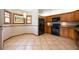 A bright kitchen with wooden cabinets, black appliances, tile flooring, and a charming windowed breakfast nook at 1609 E Kaley Ave, Orlando, FL 32806