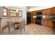 Bright kitchen boasts wood cabinets, black appliances, and a cozy breakfast nook with stylish chandelier at 1609 E Kaley Ave, Orlando, FL 32806