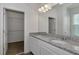 Bright bathroom featuring dual sinks, granite countertop, and walk-in closet at 16242 Outlook Shore Aly, Winter Garden, FL 34787
