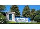 Beautiful community entrance sign surrounded by lush landscaping and clear blue skies at 16242 Outlook Shore Aly, Winter Garden, FL 34787