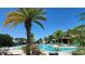 Resort-style community pool surrounded by palm trees and lounge chairs, perfect for relaxation at 16242 Outlook Shore Aly, Winter Garden, FL 34787