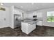 Bright kitchen features white cabinets, stainless steel appliances and center island at 16242 Outlook Shore Aly, Winter Garden, FL 34787