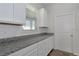 Kitchen features granite countertops and ample storage with white cabinets and modern fixtures at 16242 Outlook Shore Aly, Winter Garden, FL 34787
