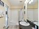 Bathroom featuring a tub and shower, a single sink vanity, and a door to the exterior at 165 Scrub Jay Way, Davenport, FL 33896