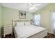 Well-lit bedroom featuring hardwood floors and a white finish bed frame and bedside tables at 165 Scrub Jay Way, Davenport, FL 33896