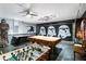 Finished basement space used as a game room featuring themed decor and games at 165 Scrub Jay Way, Davenport, FL 33896