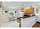 Efficient kitchen featuring modern appliances, granite countertops, and breakfast bar at 165 Scrub Jay Way, Davenport, FL 33896