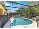 Enjoy Florida's sunshine in this private screened-in pool with a fenced yard at 165 Scrub Jay Way, Davenport, FL 33896